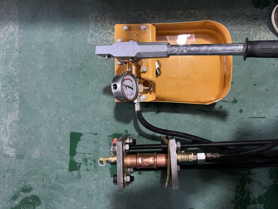 Pressure test fixture with copper fitting and hydraulic pump
