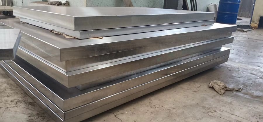 Stack of finished surface-machined steel plates