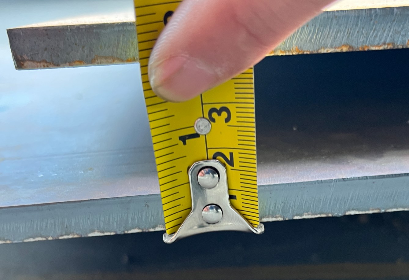 Tape measurement on steel sheet edge