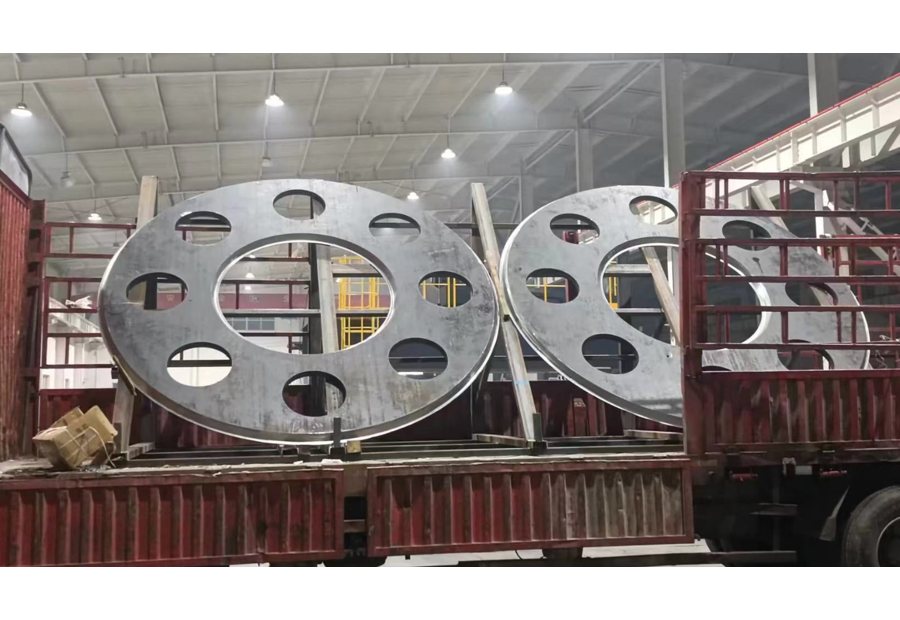 Large round steel components loaded on truck during Hercules QC inspection